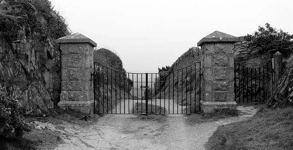 Foreboding gates restricting access to a hidden destination