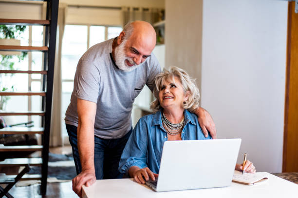 istock Senior couple using laptop at home 1371131947