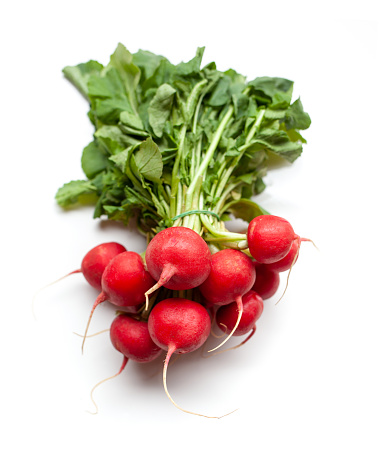 bunch of red radishes on white background. top view