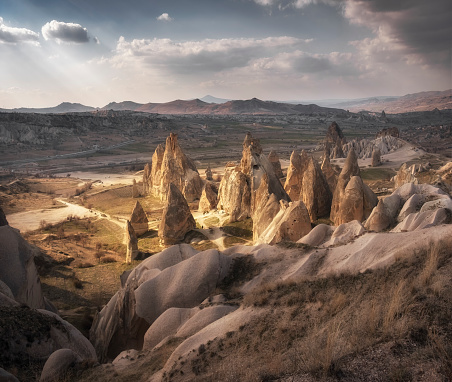 valleys of Cappadocia with quaint cliffs and mountains in Turkey at sunset