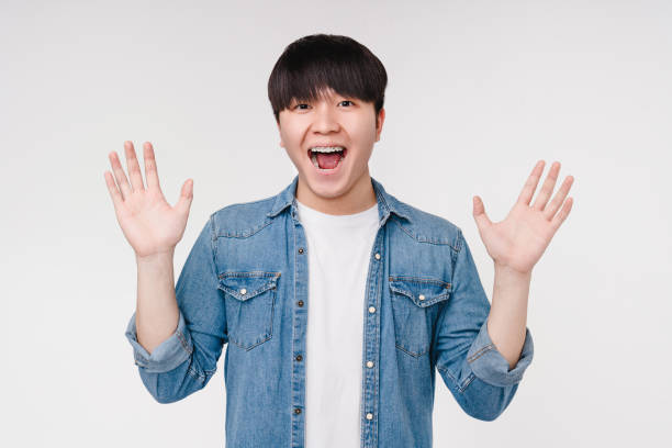 istock Extremely happy impressed surprised shocked young korean asian boy man student expressing positive emotions isolated in white background. Sale offer discount 1371135977