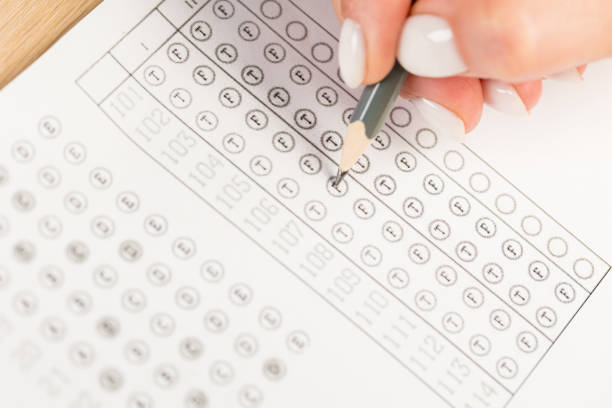 istock hand fill in Exam carbon paper computer sheet and pencil 1371139016