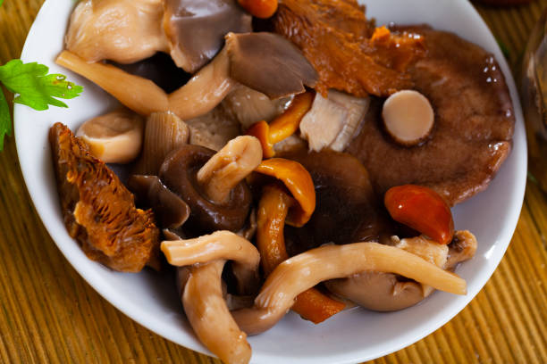 istock Assorted pickled mushrooms with onions and parsley 1371139439
