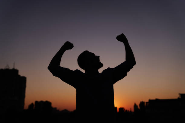 istock Feeling like a winner or happiness silhouette man at sunset 1371140808