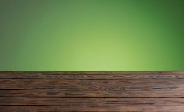 istock dark woodewn table on background bright green wall 1371141593