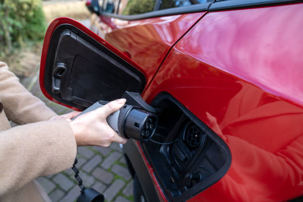 istock Charging a plug in a electric car 1371141884