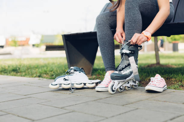 istock Young Woman Puts On Roller Skates 1371143054