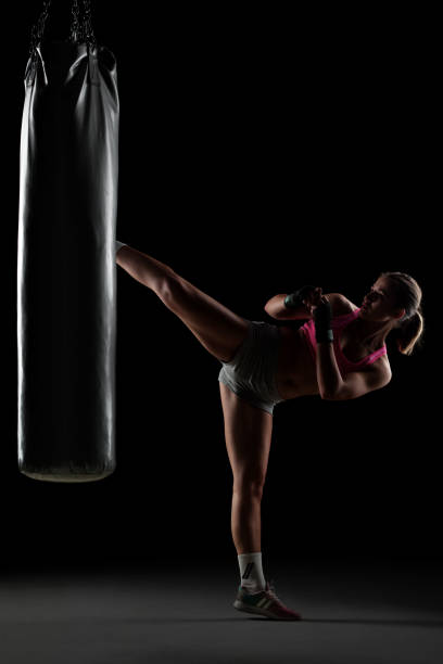 istock girl punching a boxing bag 1371146940