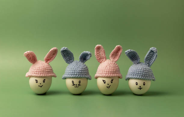 istock Trendy composition with Easter bunnies made of eggs on a green background. 1371147130