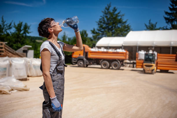 Thirsty Female Blue-collar Worker in Ore Processing Plant stock photo