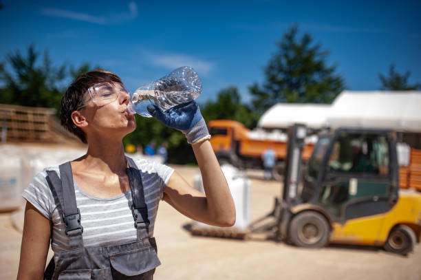istock Female Blue-collar Worker Drinking Water in Ore Processing Plant 1371148600