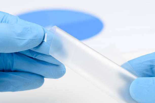 istock Scientist bend flexible semitransparent plastic like thin film material in laboratory 1371148898