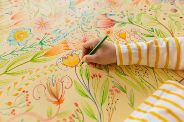 istock Unrecognizable creative schoolboy, drawing the art with plants and flowers 1371150220