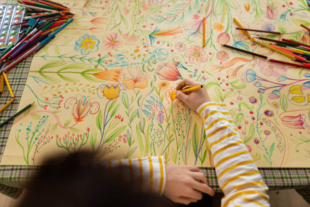 istock High angle view of unrecognizable creative boy drawing the plants and flowers 1371150351
