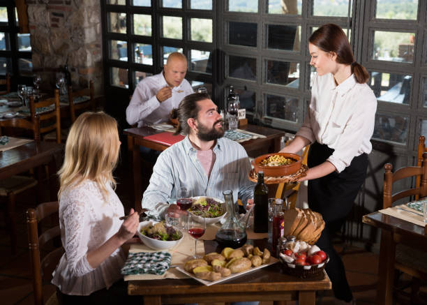 istock Happy people having dinner at rural restaurant and drinking wine 1371151756
