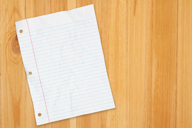 Retro lined school crumpled paper background on wood desk with copy space for your school message