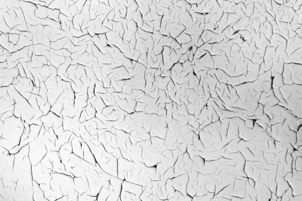 istock White cracked texture. Damaged, aged and weathered surface. 1371153615