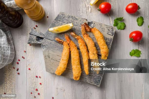 Fried Tempura Shrimps With Lemon On Wooden Board Top View Stock Photo - Download Image Now