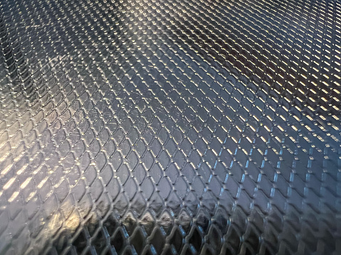 Shiny metal with a pattern.