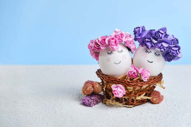 istock Two cuddling Easter eggs with sweet faces in floral spring wreaths 1371155193
