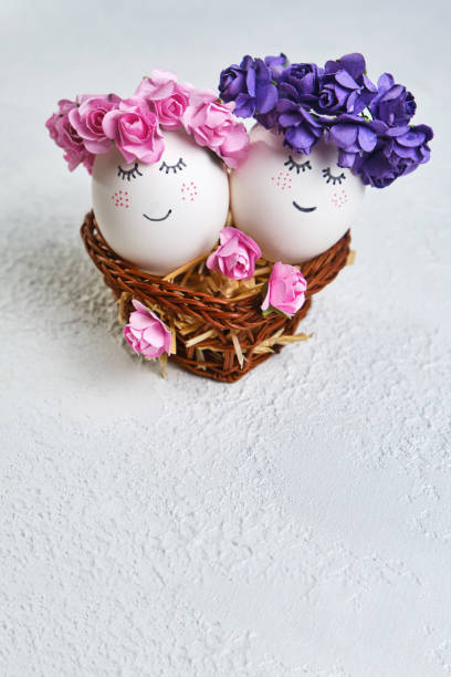 istock Two cuddling Easter eggs with sweet faces in floral spring wreaths 1371155199