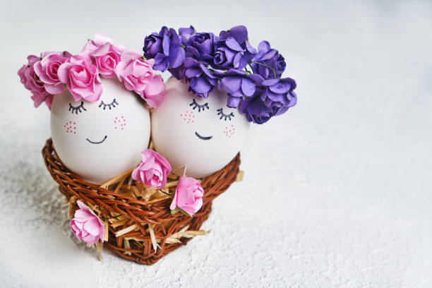 istock Two cuddling Easter eggs with sweet faces in floral spring wreaths 1371155209