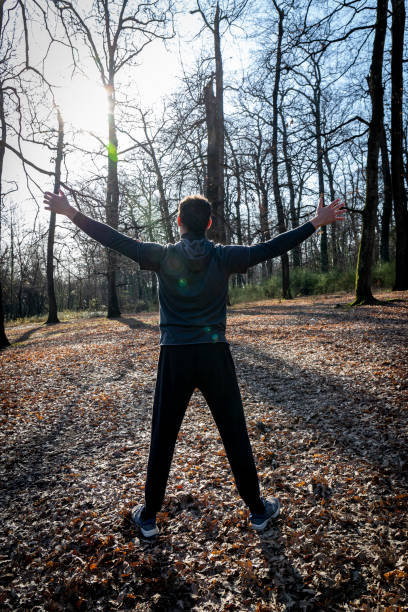 istock The runner is stretching in the forest. 1371155836