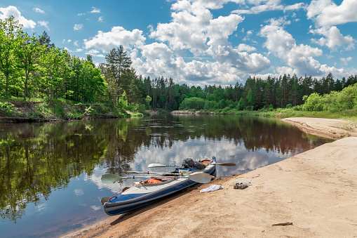 Outdoor activities forest river reflection of sky and kayak bright image of kayak view on right