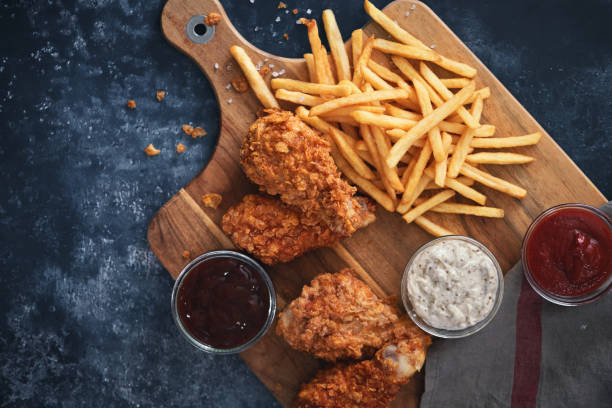 istock Crispy Fried Chicken Drumsticks with French Fries 1371157889