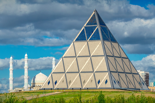 The Palace of Peace and Reconciliation, aka Pyramid of Peace and Accord, in Nur-Sultan Kazakhstan on a sunny day. It serves as a non-denominational spiritual center and an event venue.