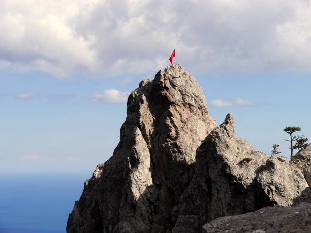 istock Red flag on the mountain peak 1371159183