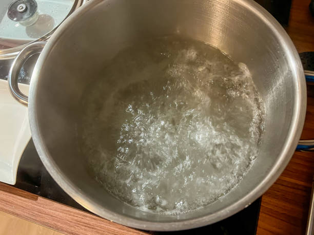 istock Boiling water in a large iron pot. 1371159233