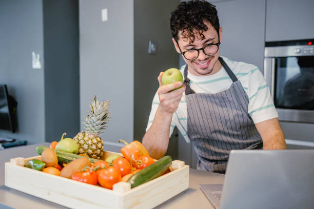 istock Young man reading online recipes in the kitchen 1371160475