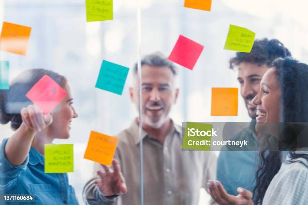 Group Of Business People Brainstorming Stock Photo - Download Image Now - Innovation, Adhesive Note, Teamwork
