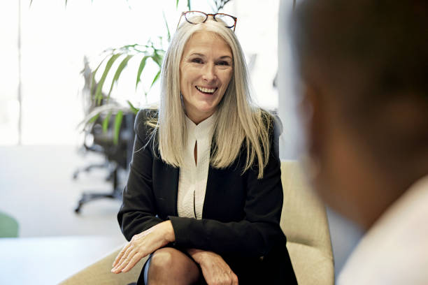 istock Cheerful executive conversing with male colleague in office 1371160689