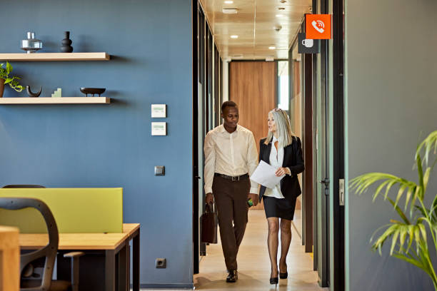 istock Young job candidate walking through office with interviewer 1371160694
