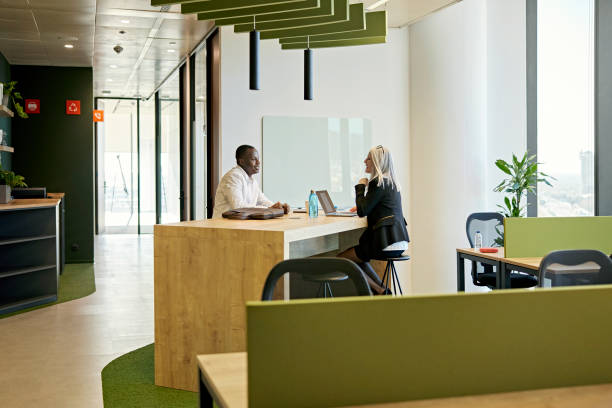 istock Female executive and businessman exchanging ideas 1371160696