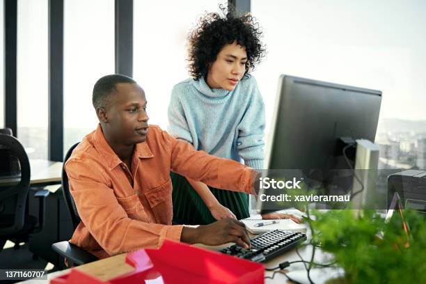 Young Business Partners Working On Project In Modern Office Stock Photo - Download Image Now