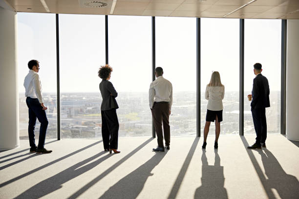 istock Diverse executives standing together in afternoon sunlight 1371160716