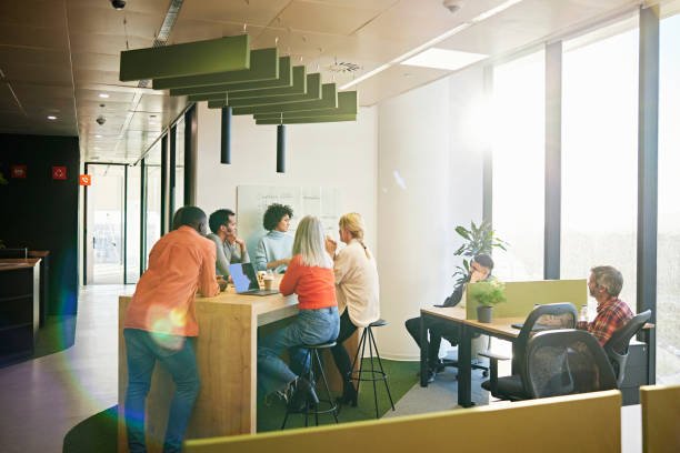 Business people gathered for meeting in open plan office stock photo