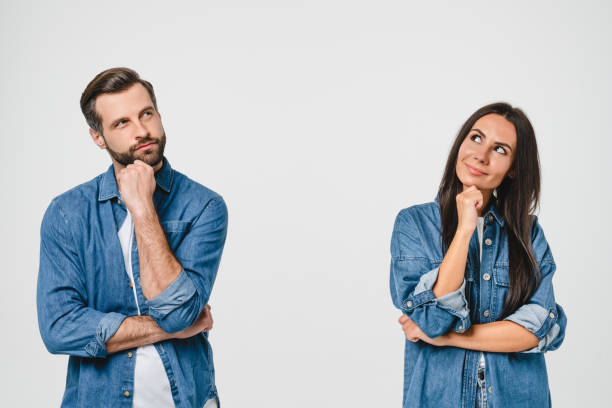 istock Thoughtful pensive caucasian young couple looking upwards for free space copyspace, thinking new ideas, planning for future together isolated in white background 1371161436