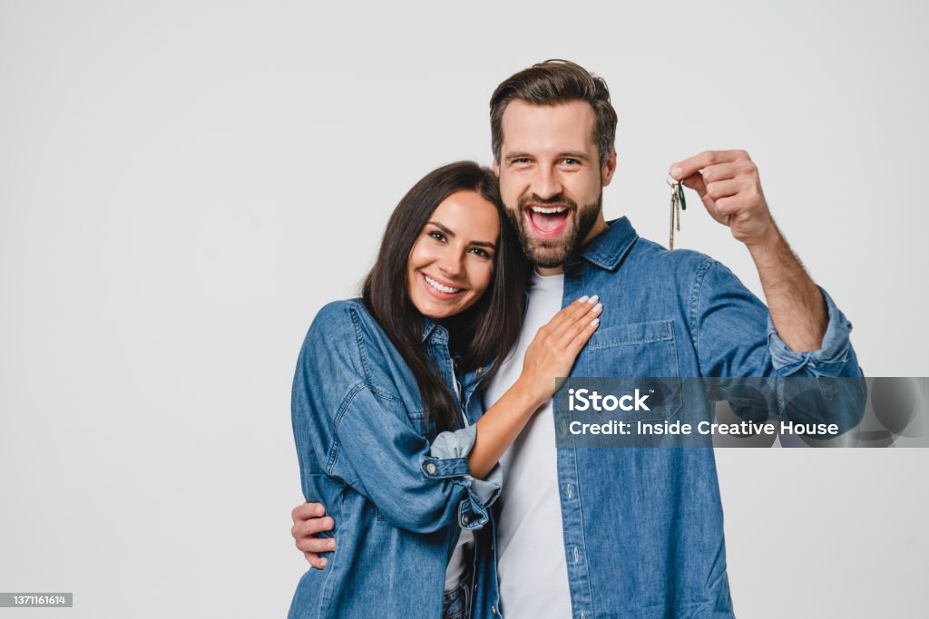 Homeowners. Happy young caucasian couple spouses wife and husband holding car house flat appartment keys, celebrating new purchase buying real estate isolated in white background. Mortgage loan - Royalty-free Koppel Stockfoto Homeowners. Happy young caucasian couple spouses wife and husband holding car house flat appartment keys, celebrating new purchase buying real estate isolated in white background. Mortgage loan - Royalty-free Koppel Stockfoto