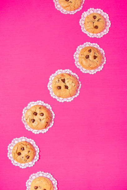 Homemade chocolate chip cookies on a bright pink background