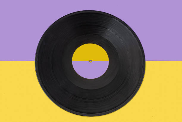 istock Vinyl record centered on a yellow and purple background. 1371161883