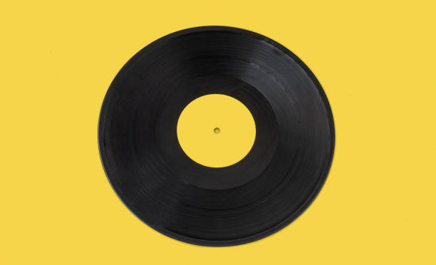 istock Vinyl record centered on a yellow background. 1371161888
