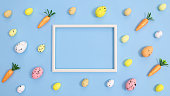 Easter background pattern with colorful eggs and circle frame on pastel cyan theme. Flat lay creative copy space. Minimal concept