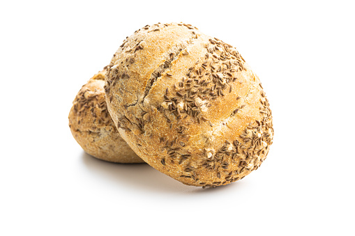 Baked bun bread with cumin seeds isolated on a white background.