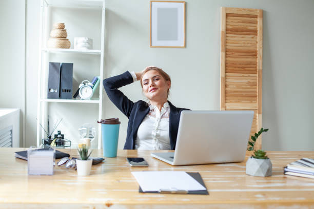 istock Laughing business woman in office 1371164882