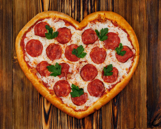 istock heart shaped pizza on wooden background for restaurant menu4 1371166052