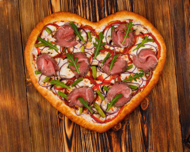 istock heart shaped pizza on wooden background for restaurant menu1 1371166068